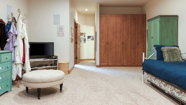 A bedroom with a bed, a TV, a wardrobe, and a dresser. - Maison de Neige Breathtaking Mountain Stay for 8 w/ Hot Tub (Vail)