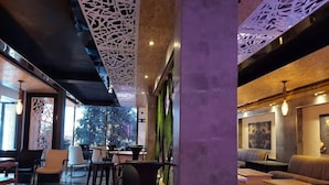 Een modern interieur met een bar, zitplaatsen en uitzicht op de omgeving.