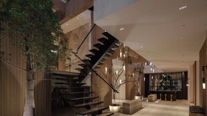 A modern interior with a staircase, wooden paneling, and a bar area. - Royal Oak - Exquisite Estate with Infinity Pool & Breathtaking Views (Encino)