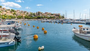 A marina with boats, yellow buoys, and a hillside town in the background. - Apartment 'Astros' with Balcony (Paralio Astros)