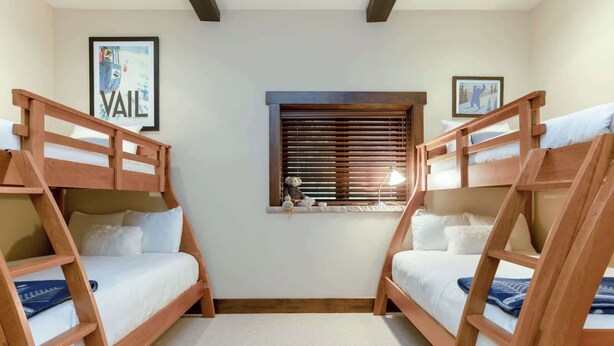 A room with two bunk beds, a window with blinds, and a framed picture on the wall. - Basingdale Hollow - For 10 (Vail)