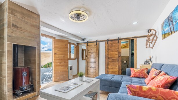 A modern living room with a fireplace, a sofa, and a coffee table.