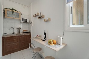 Fridge, microwave, stovetop, coffee/tea maker