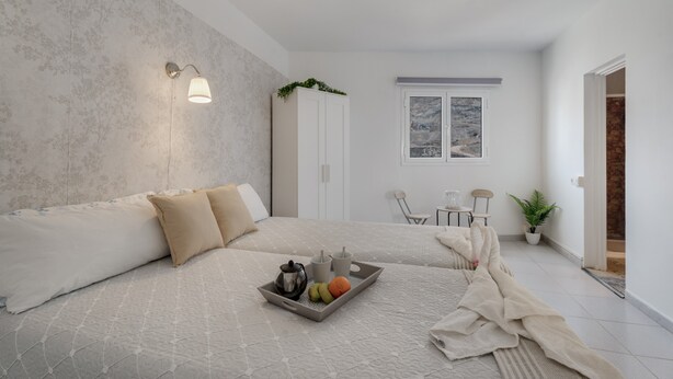 A modern bedroom with a bed, bedside table, and a tray with fruits and a teapot. - Apartment 'Candelaria C' with Wi-Fi (Valle Gran Rey)