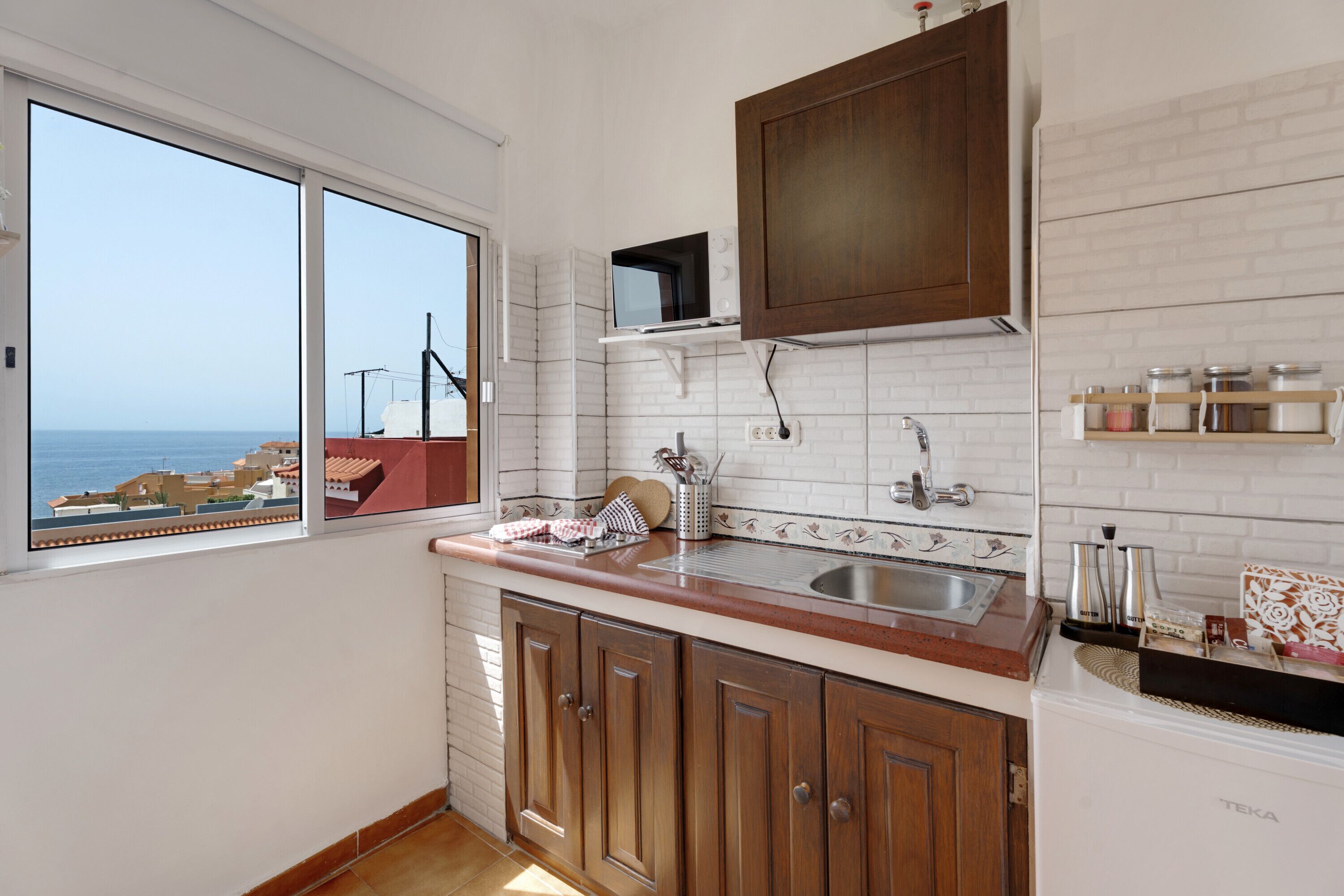 Fridge, microwave, stovetop, coffee/tea maker