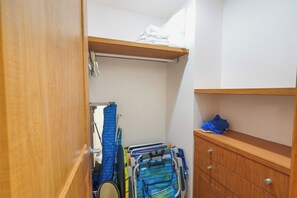 A compact room with a wooden wardrobe, a small shelf, and a bed with white bedding. - Sleeps 10, Views & Beach 1 Block (Nuevo Vallarta)