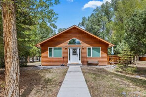 A small log cabin with a front porch, a bench, and a pathway leading to the entrance. - Hot Tub, Game Room, Mtn Views Near Ski & River (South Fork)