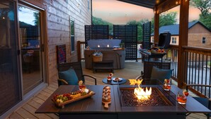 An outdoor deck with a fire pit, seating, and a grill area. - Close to Thunder Ridge, Luxury Cabin, Pools (Hollister)