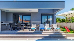 A modern house with a pool, outdoor seating, and a slide. - Istriensonne 0785 - Newly built semi-detached house Double1 with private pool (Loborika)