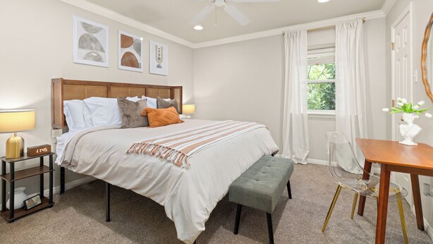 A bedroom with a bed, bedside tables, a desk, and a chair. - 
Travis Heights Modern Getaway - Corporate Housing Rental (Austin)