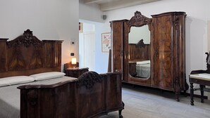 Ein Schlafzimmer mit einem hölzernen Bett, einem Kleiderschrank und einem Spiegel.
