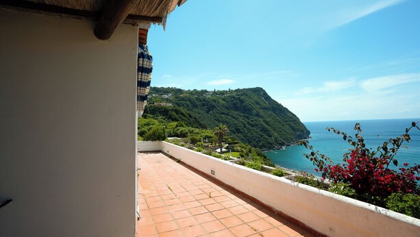 A balcony with a view of the sea and a mountainous landscape. - Villa La Pigrizia - One Bedroom Villa, Sleeps 2 (Forio)