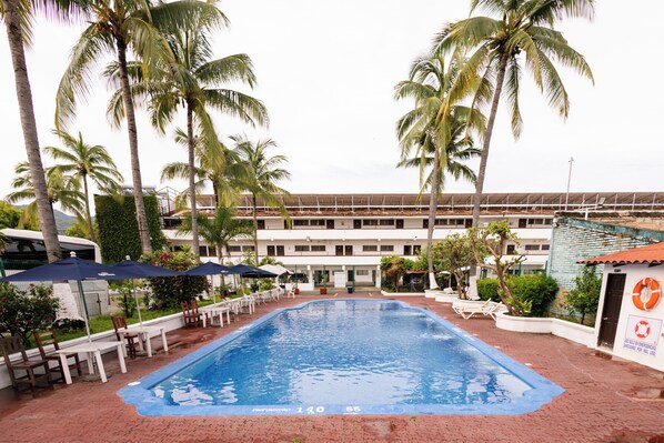 Outdoor pool, open 9:00 AM to 9:00 PM, pool umbrellas, pool loungers