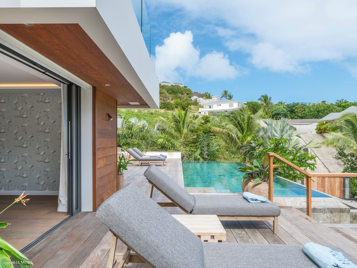 Sun deck with loungers facing the lagoon