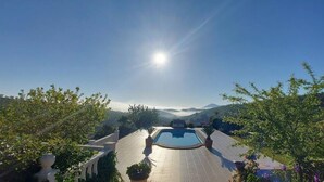 A swimming pool with a view of mountains and a clear sky.