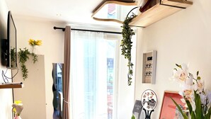 A modern bedroom with a bed, bedside table, and a small desk area. - Comfortable studio near Paris-Orly airport (Villeneuve-le-Roi)