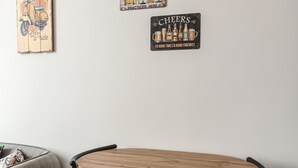 A dining area with a wooden table and black metal chairs.