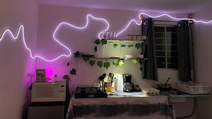 A kitchen with a microwave, coffee maker, and various kitchen items on the counter.