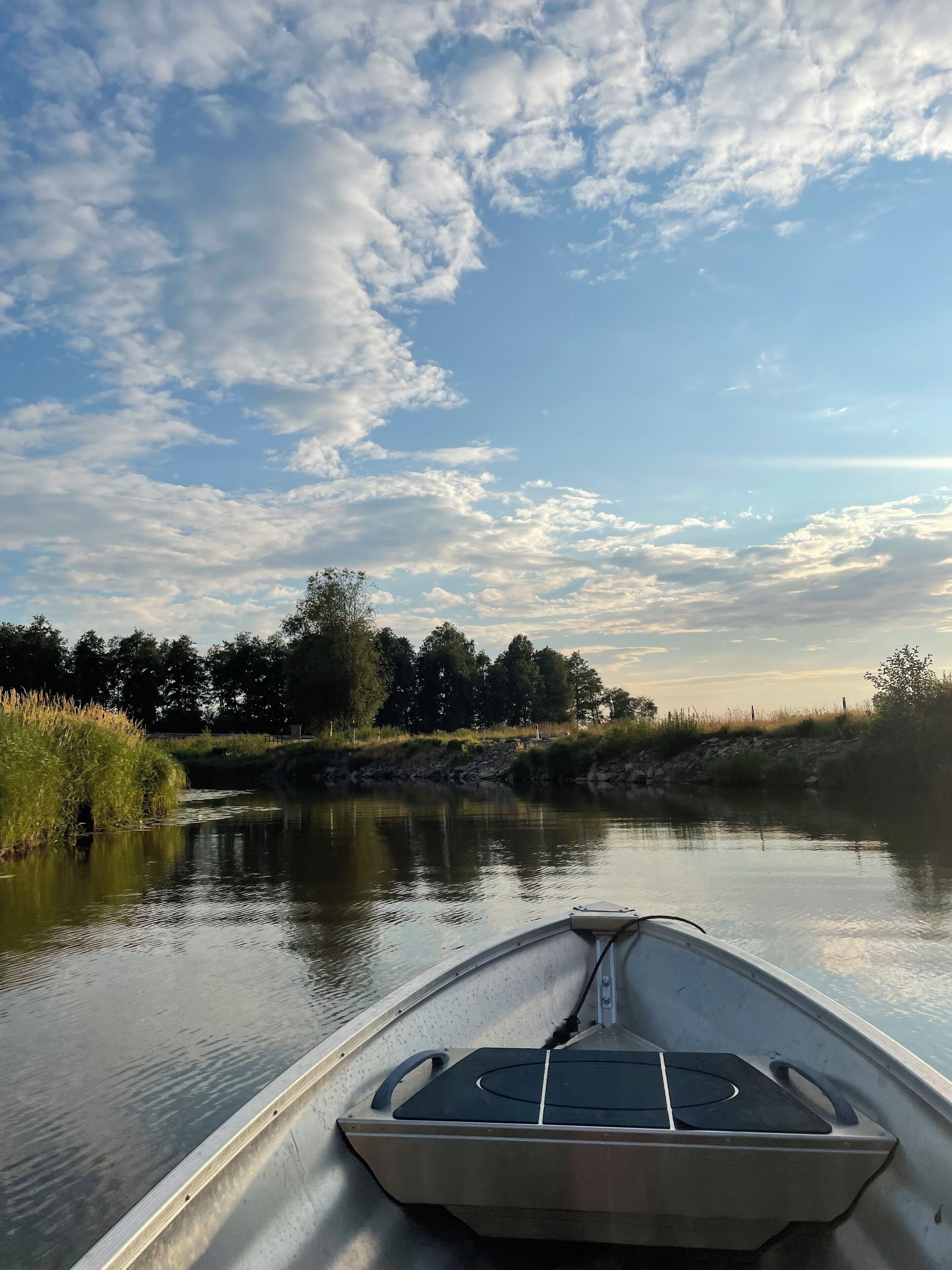 A narrow waterway with a boat in the foreground.