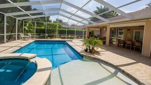 A covered swimming pool with a glass ceiling, surrounded by a patio area with outdoor furniture. - Charming Golf Retreat - Pool/hot tub sleep 6 (Inverness)