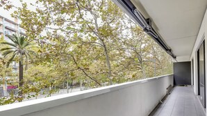 A balcony with a view of trees and buildings. - Stay U-nique Apartments Diagonal Mar (Barcelona)