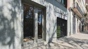 A modern building with large glass doors and windows, a metal gate, and a paved sidewalk. - Stay U-nique Apartments Sants II (Barcelona)