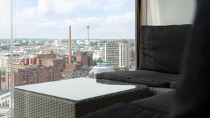A city view from a high-rise room with a large window, a sofa, and a small table. - Come in! `Wallesmanni` Best location in Tampere! (Tampere)