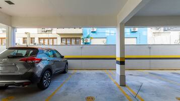 A parking garage with a car parked in a designated spot.