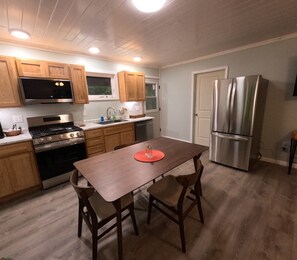 Fridge, microwave, oven, stovetop - 3BR Lacona Cabin: AC, Trails Access, Family + Pet-Friendly (Lacona)