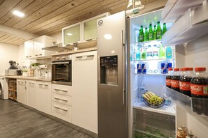 Fridge, dishwasher, coffee/tea maker, dining tables