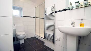 Shower, hair dryer, towels, toilet paper