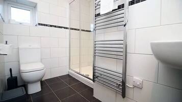 Shower, hair dryer, towels, toilet paper