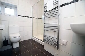 Shower, hair dryer, towels, toilet paper