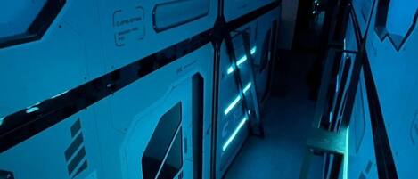 A series of white lockers with blue LED lighting and the letters "CFS" on them.