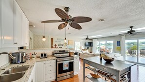 A modern kitchen with white cabinets, stainless steel appliances, and a central island. - Dock & Kayaks: Lake-View Home, 29 Mi to Notre Dame (Union)