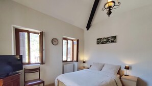 A bedroom with a bed, bedside tables, a chair, a television, and a clock on the wall. - Ilonse's Planet 2 (ILONSE)