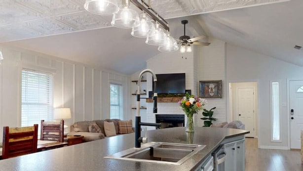 A spacious kitchen with a large island, modern appliances, and pendant lighting.