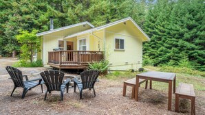 A yellow cabin with a deck, surrounded by dense forest. - Coastal Redwood Bliss | Little River (Little River)