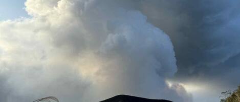 A mountain landscape with a large cloud formation.