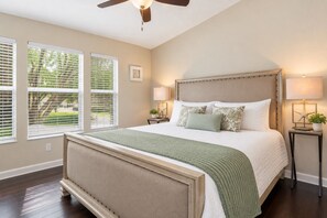 A bedroom with a large bed, two bedside tables, a ceiling fan, and windows with blinds. - Amazing 3BDR House w/ pool (Kissimmee)