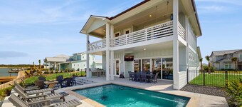 Stunning canal front home with private pool, fire pit, and boat dock