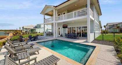 Stunning canal front home with private pool, fire pit, and boat dock