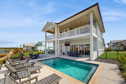 Stunning canal front home with private pool, fire pit, and boat dock