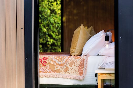 1 bedroom, bed sheets. Dreamseed Cabin by Tiny Away