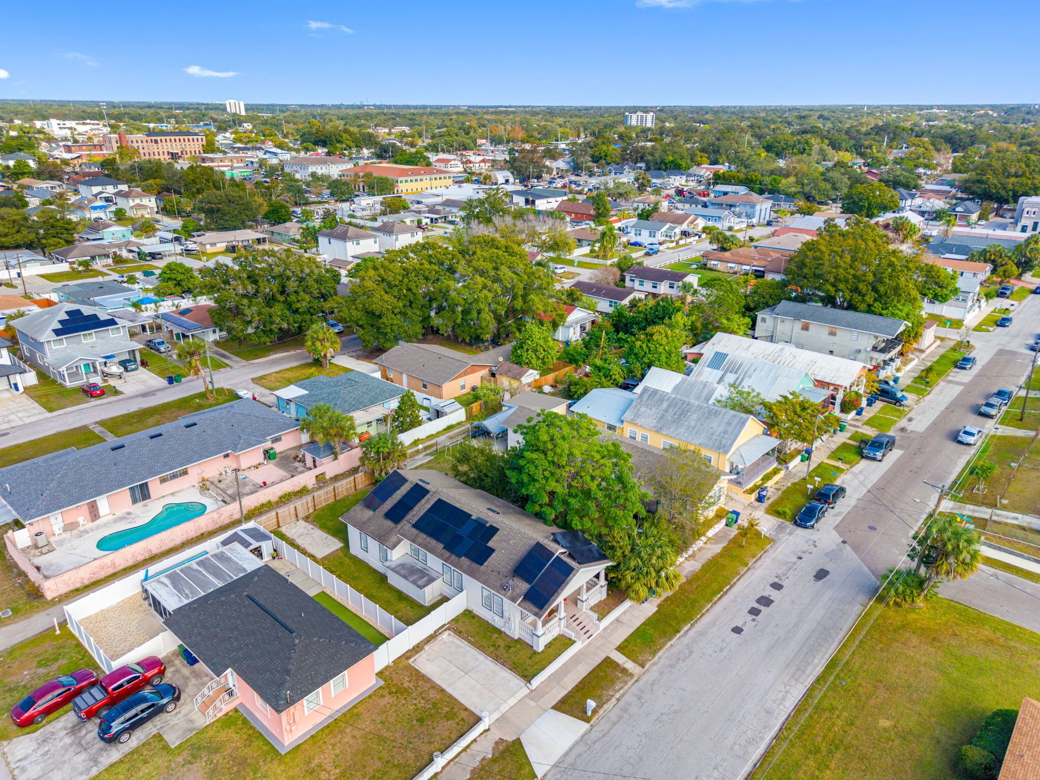 An aerial view of a residential neighborhood with houses, streets, and parked cars.