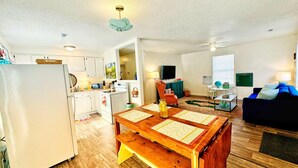 A compact living space with a kitchen, dining area, and seating area. - Cozy, Country Cottage (Travelers Rest)