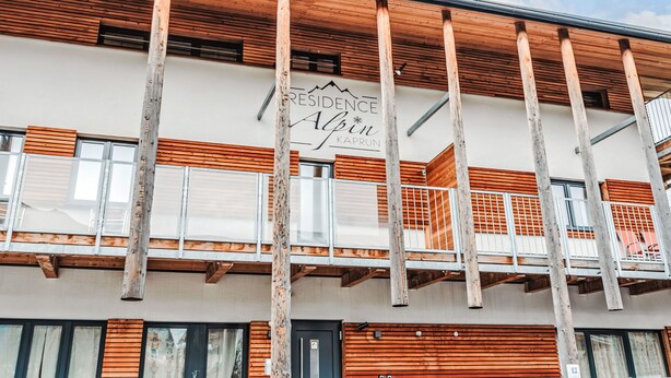 A building with a sign reading "RESIDENCE ABIN KAPRUN" and a balcony with wooden railings. - Justine (Top 9) by Interhome (Kaprun)