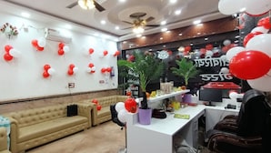 A room with a sofa, a desk, and a potted plant. - Sanwariya Guest House And Resort (Danta Ramgarh)