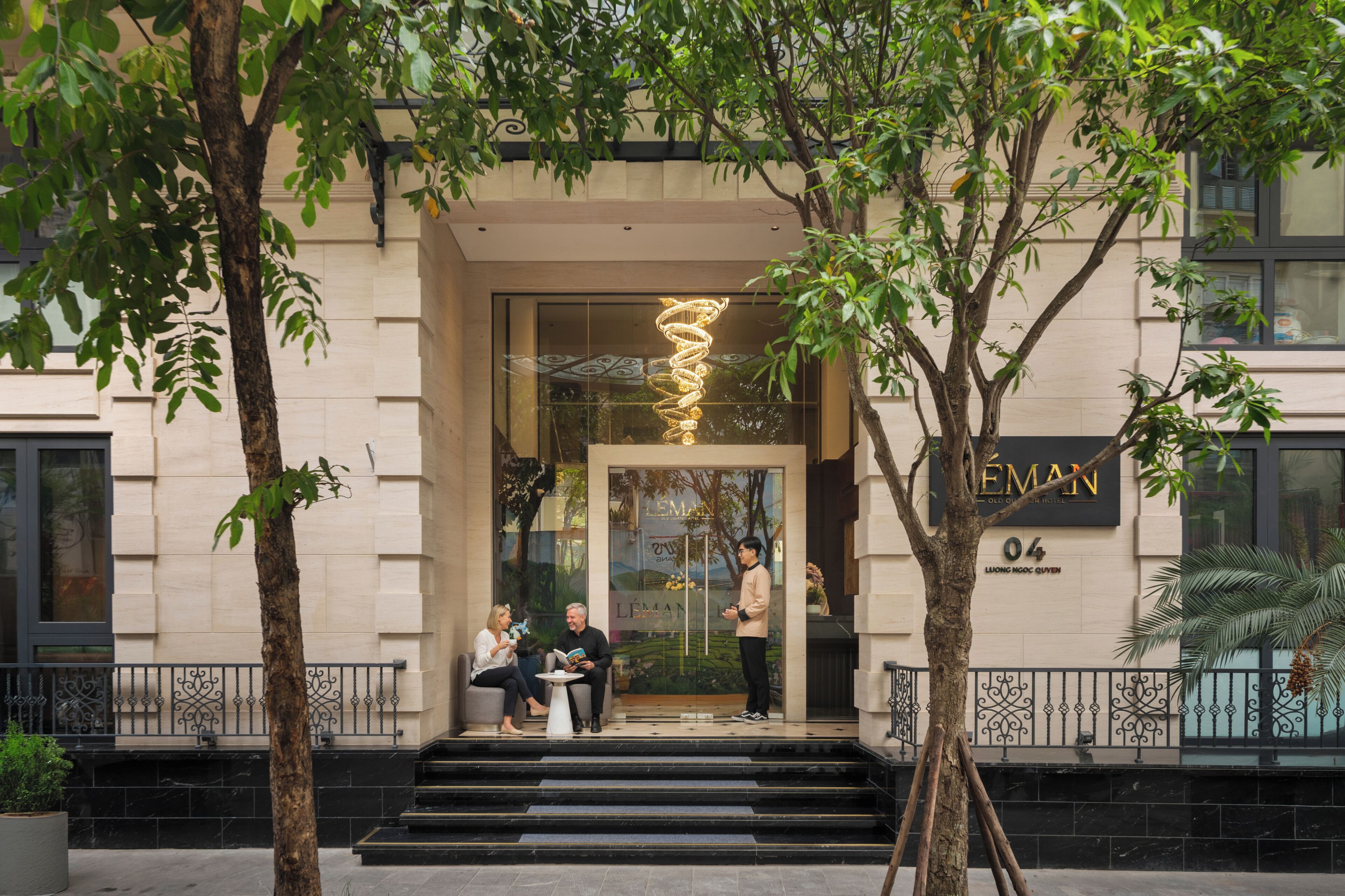A building entrance with a spiral light fixture, a sign reading 'LEMAN,' and a number '04' on the wall.