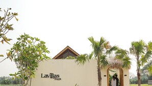 A building with a sign reading "Lavillas Jogja" and a person standing at the entrance. - Lavillas Jogja (Sleman)